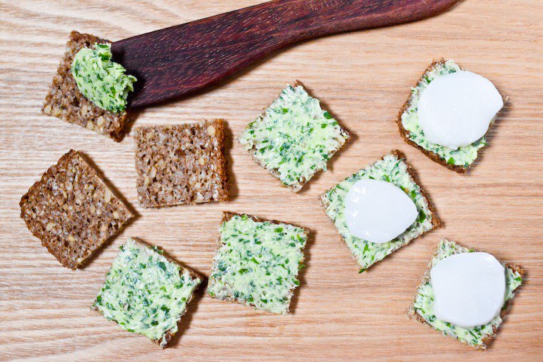 A chic yet easy nibble. Learn how to make herbed butter! Spread it on pumpernickel bread with a sliced scallop on top. Great for a special occasion buffet!